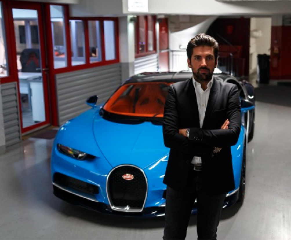 Alexandre Kejejian standing in front of a blue Bugatti
